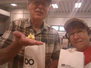 Two people with bags of popcorn